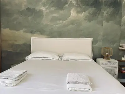 a bedroom with a white bed with two towels on it at superbe appartement centre Cannes in Cannes