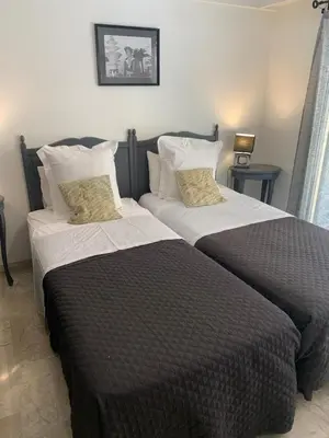 two beds sitting next to each other in a bedroom at Appart Le Cannet in Le Cannet