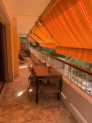 a balcony with a table and chairs on it at Appart Le Cannet in Le Cannet
