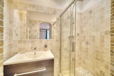 a bathroom with a sink and a shower at CROISETTE 8/10 pers in Cannes