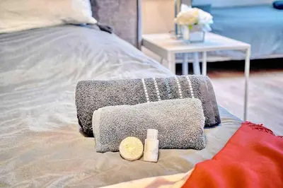 a bed with two towels on top of it at CROISETTE 8/10 pers in Cannes