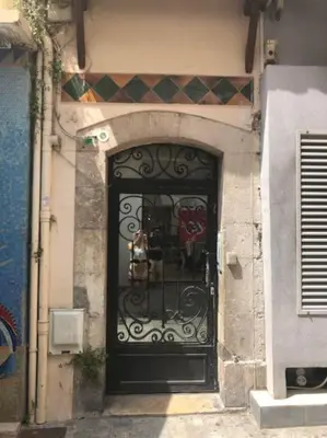 a black door in the side of a building at CROISETTE 8/10 pers in Cannes
