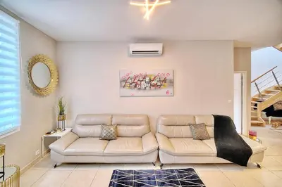 a living room with a couch and a table at CROISETTE 8/10 pers in Cannes