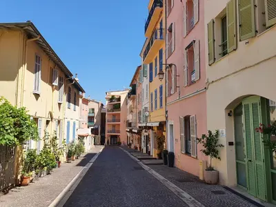 an empty street in a town with colorful buildings at Suquet 22 – 2 Pièces, Cannes Cœur Historique, Calme, Plage à 300m, Parking in Cannes