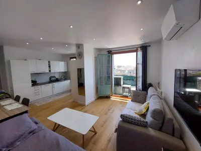 a living room with a couch and a table at Cannes centre, super cosy apartment near everything in Cannes