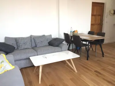 a living room with a couch and a table at Cannes centre, super cosy apartment near everything in Cannes