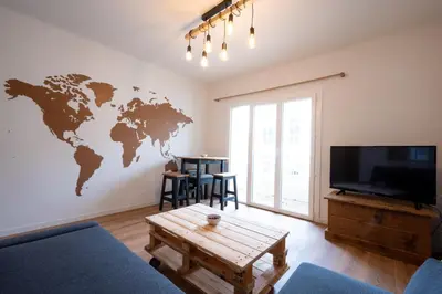 a living room with a world map on the wall at Tredici- Appartment in Cannes