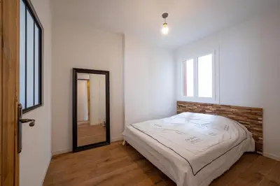 a bedroom with a bed and a brick wall at Tredici- Appartment in Cannes