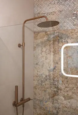 a shower with a glass door in a bathroom at Tredici- Appartment in Cannes