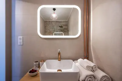a bathroom with a sink and a mirror at Tredici- Appartment in Cannes