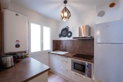 a kitchen with a white refrigerator and a sink at Tredici- Appartment in Cannes