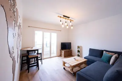 a living room with a couch and a table at Tredici- Appartment in Cannes