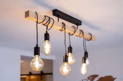 a cluster of lights hanging from a ceiling at Tredici- Appartment in Cannes