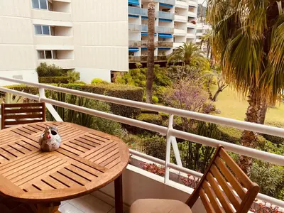 a wooden table and chairs on a balcony at MON2-Studio spacieux Cannes centre in Cannes