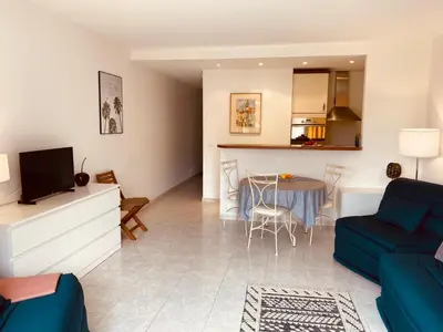 a living room with a blue couch and a table at MON2-Studio spacieux Cannes centre in Cannes
