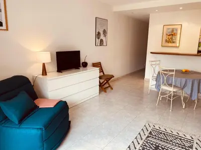 a living room with a blue couch and a tv at MON2-Studio spacieux Cannes centre in Cannes