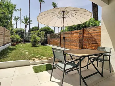 two twin beds in a room with curtains at Beautiful 1 bedroom with garden on the Croisette 254 in Cannes