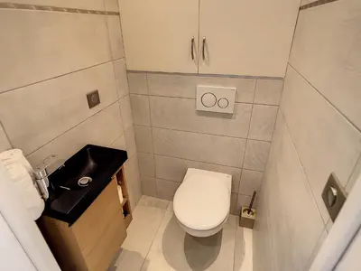 a kitchen with stainless steel appliances and tile floors at Beautiful 1 bedroom with garden on the Croisette 254 in Cannes