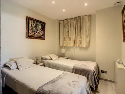 a living room with a blue couch and a table at Beautiful 1 bedroom with garden on the Croisette 254 in Cannes