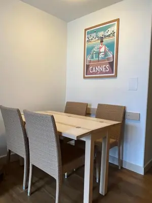 a dining room table with chairs and a picture on the wall at Superbe appartement une chambre vue mer piscine tennis in Cannes