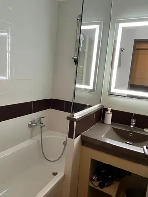 a bathroom with a tub and a sink and a shower at Superbe appartement une chambre vue mer piscine tennis in Cannes