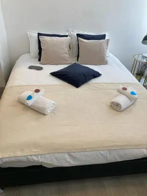 a bed with two pairs of towels on it at Cannes: superbe studio x3 personnes, top position! in Cannes