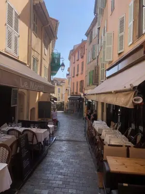 an empty street with tables and chairs and buildings at Cozy studio apartment in Cannes - AC-Self check-in in Cannes