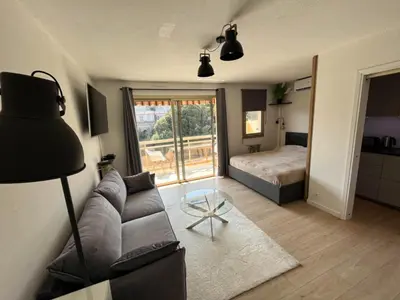a living room with a couch and a bed at Cozy studio apartment in Cannes - AC-Self check-in in Cannes