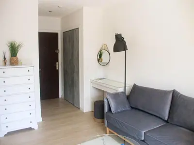 a living room with a couch and a table at Cozy studio apartment in Cannes - AC-Self check-in in Cannes
