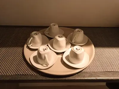 a plate with four cups and saucers on a table at L'étoile pétillante in Cannes