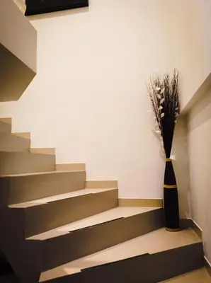 a staircase with a vase of flowers in a room at L'étoile pétillante in Cannes