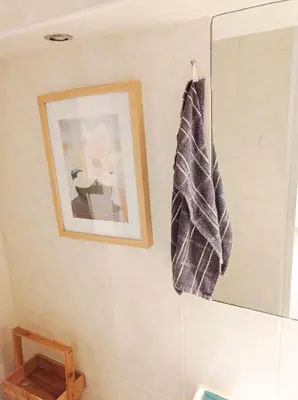 a bathroom with a mirror and a towel on the wall at L'étoile pétillante in Cannes