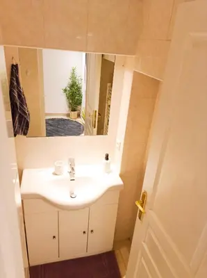 a bathroom with a white sink and a mirror at L'étoile pétillante in Cannes