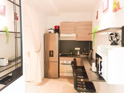 a small kitchen with a stainless steel refrigerator at L'étoile pétillante in Cannes