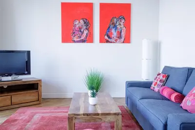a living room with a blue couch and a table at Bel Appartement Face à La Mer Près Du Centre - Le Voilier by Halldis in Cannes