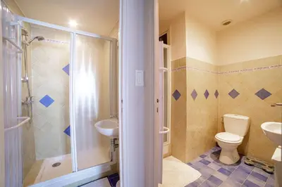 a bathroom with a toilet and a sink and a shower at Bel Appartement Face à La Mer Près Du Centre - Le Voilier by Halldis in Cannes