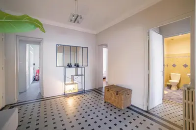 a hallway with a room with a toilet and a table at Bel Appartement Face à La Mer Près Du Centre - Le Voilier by Halldis in Cannes