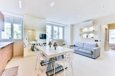 a kitchen and living room with a table and chairs at Cosy flat with parking - Basse Californie - Cannes in Cannes