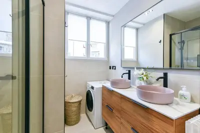 a bathroom with two sinks and a washing machine at Cosy flat with parking - Basse Californie - Cannes in Cannes