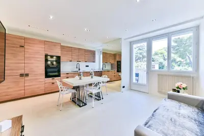 a kitchen and living room with a table and chairs at Cosy flat with parking - Basse Californie - Cannes in Cannes