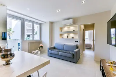 a living room with a couch and a table at Cosy flat with parking - Basse Californie - Cannes in Cannes