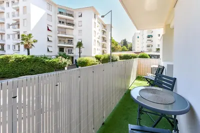 a balcony with a table and chairs and a fence at Cosy flat with parking - Basse Californie - Cannes in Cannes