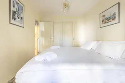 a bedroom with a large white bed with towels on it at LB Vacation Rentals I Cannes Croisette, Large Terrace, Free Parking, Beaches in Cannes