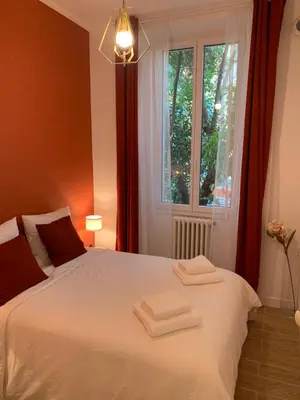 a bedroom with a bed with two towels on it at Villa Les Fougeres 2p jardin parking in Cannes