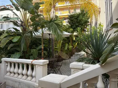a balcony with a bunch of plants in a building at Villa Les Fougeres 2p jardin parking in Cannes