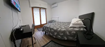 a bedroom with a bed and a television in a room at Studio confortable 10 min du Palais des festivals in Cannes