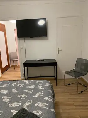 a room with a bed and a desk and a chair at Studio confortable 10 min du Palais des festivals in Cannes