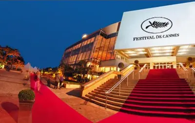 a red carpeted staircase in front of a building at Studio confortable 10 min du Palais des festivals in Cannes