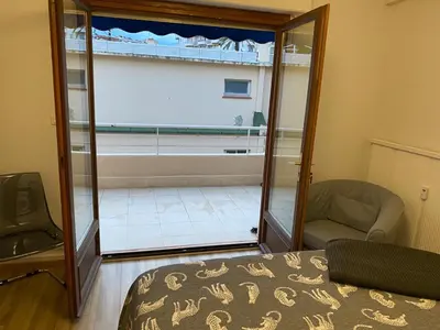 a bedroom with a glass door leading to a tub at Studio confortable 10 min du Palais des festivals in Cannes