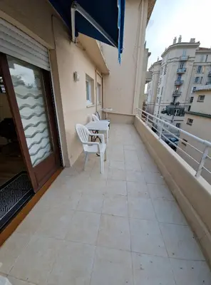 a balcony with a table and chairs on a building at Studio confortable 10 min du Palais des festivals in Cannes